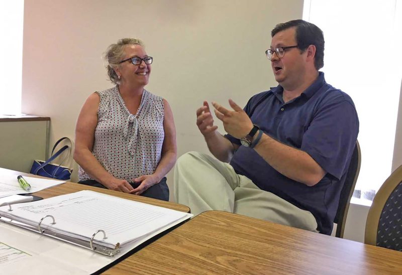 Ann Strachan talks about the future of the Granite Pathways Manchester clubhouse with longtime member Dan Radlinski. (Photo courtesy of Shawne Wickham, Union Leader.)