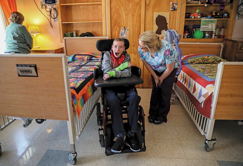 Justin Milliken laughs with Sue-Ellen Provenchia, a licensed nurse assistant at Cedarcrest. (Photo by Cheryl Senter.)