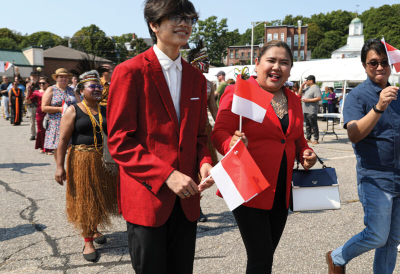 Raude Raychel waves the Indonesian flag at the 2022 Somersworth Indonesian Festival. (Photo by Cheryl Senter.)
