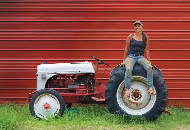 Andal Sundaramurthy of Nalla Farm with "Clyde," her 1948 Ford 8N tractor. (Photo by Cheryl Senter.)