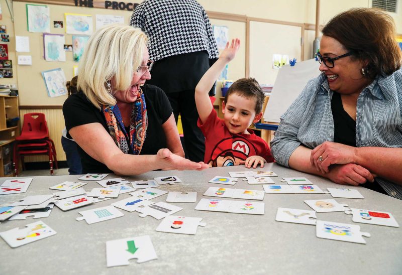 Teacher Martha Sharp (left) works with Lincoln and behavior support coach Stephanie Therrien at Easterseals Child Development Center in Manchester. (Photo by Cheryl Senter.)